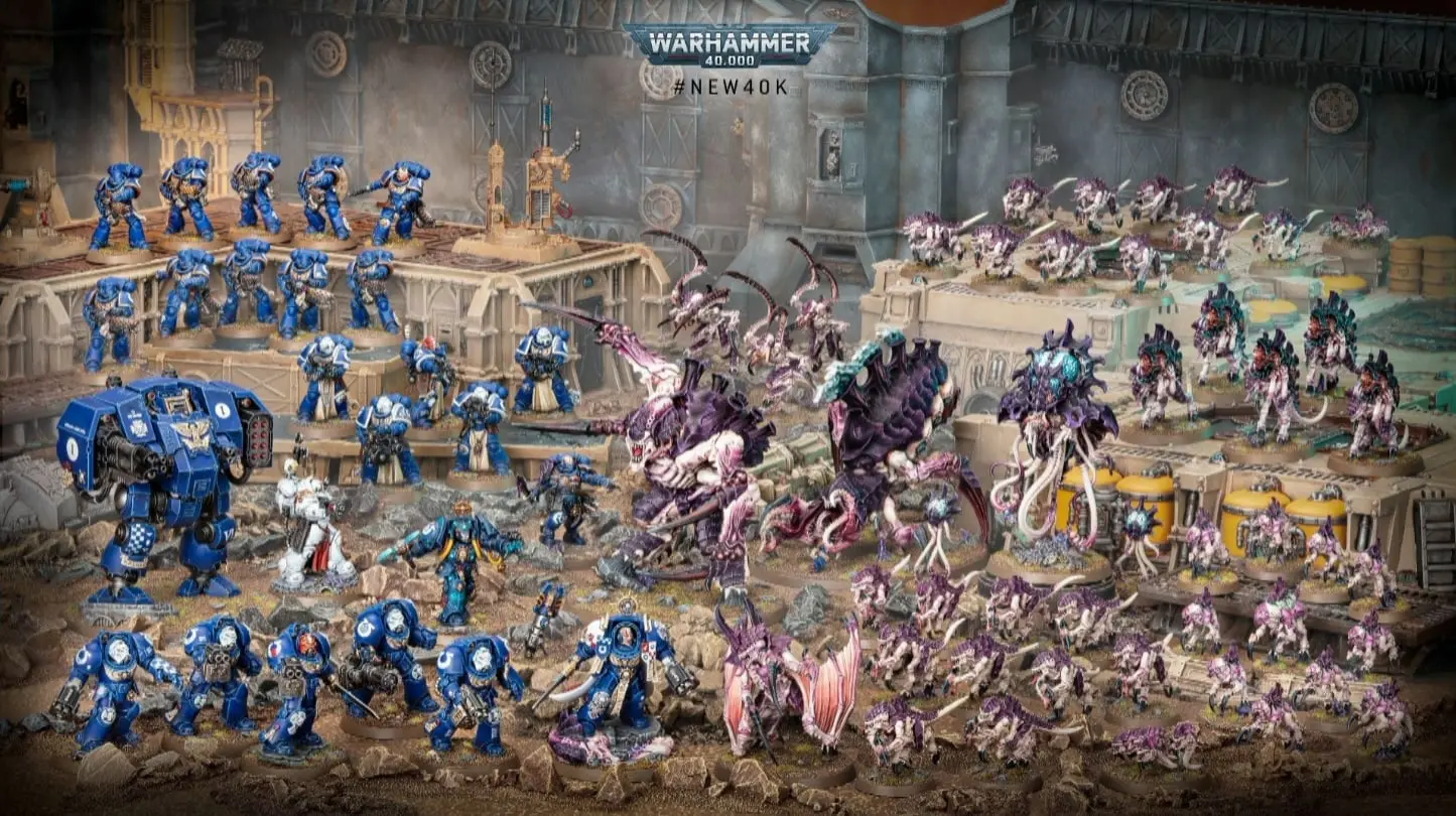 Warhammer 40000 figures, featuring blue Space Marines and various enemies.