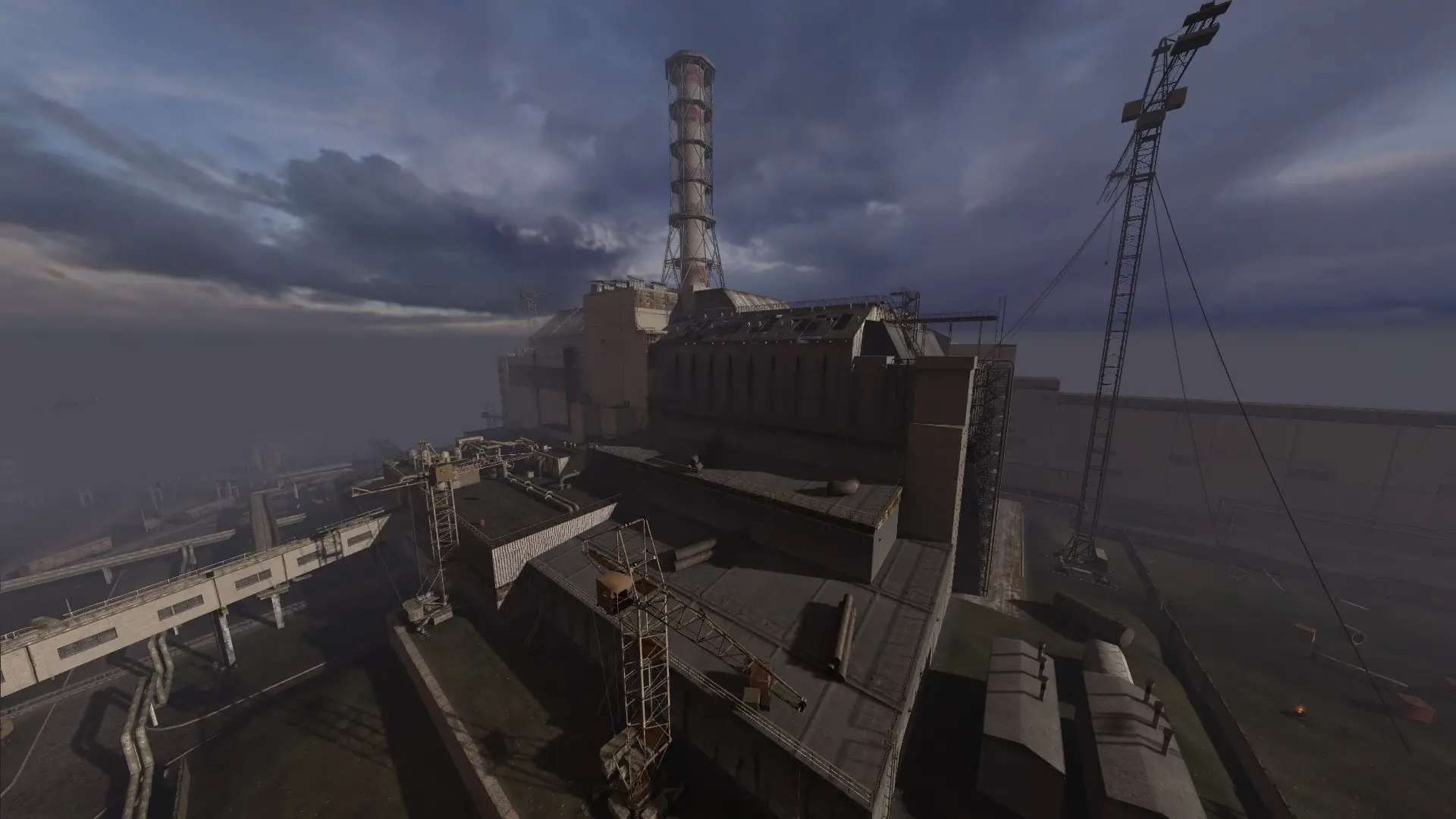 A wide shot of the Chernobyl Nuclear Power Plant industrial complex under a cloudy, atmospheric sky.